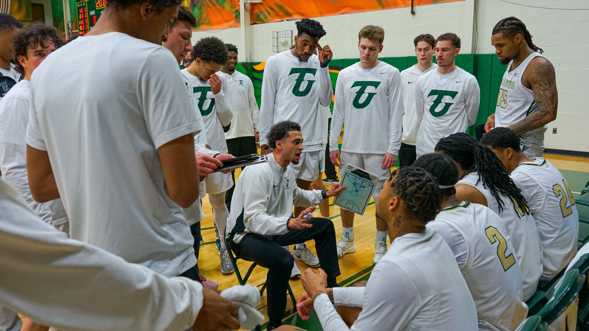 Tiffin University Men's Basketball Photo - Coach talking in team huddle